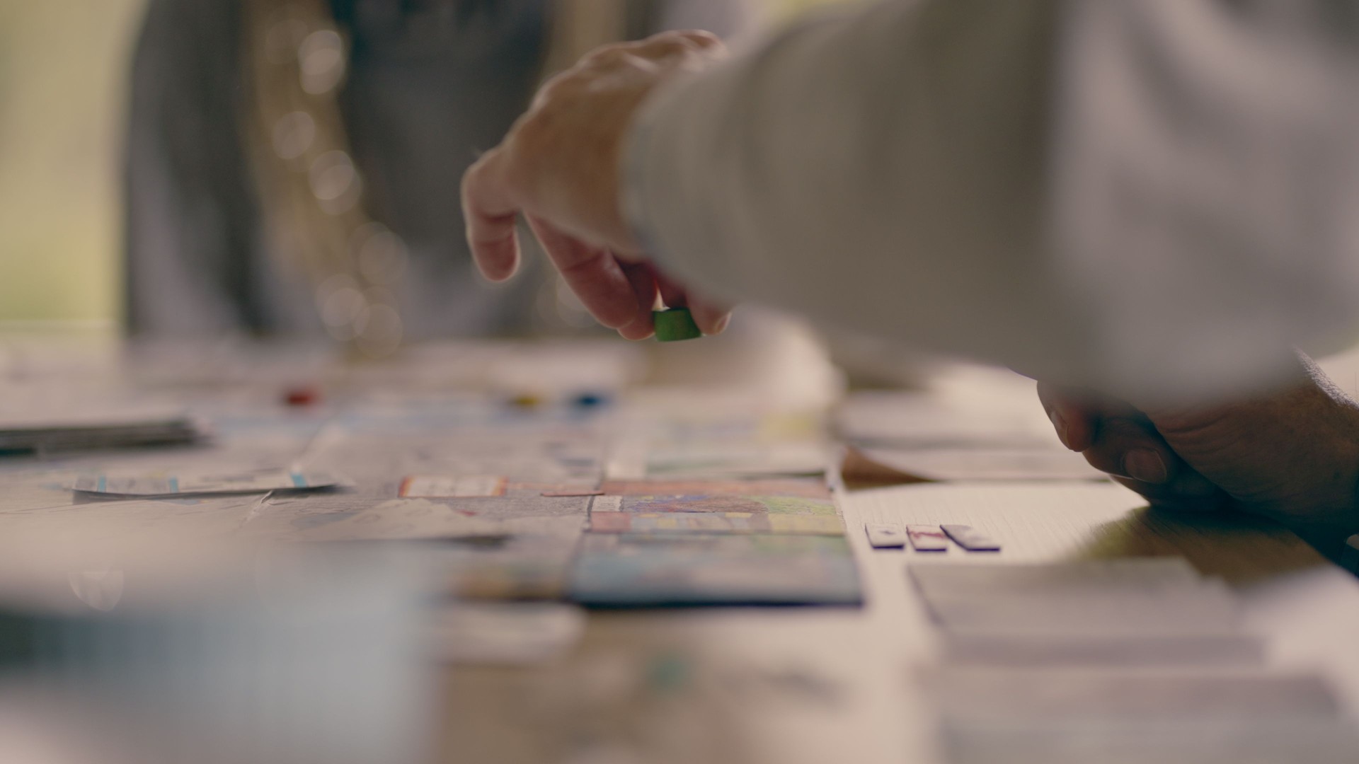 Human hand moving the pieces on a game board