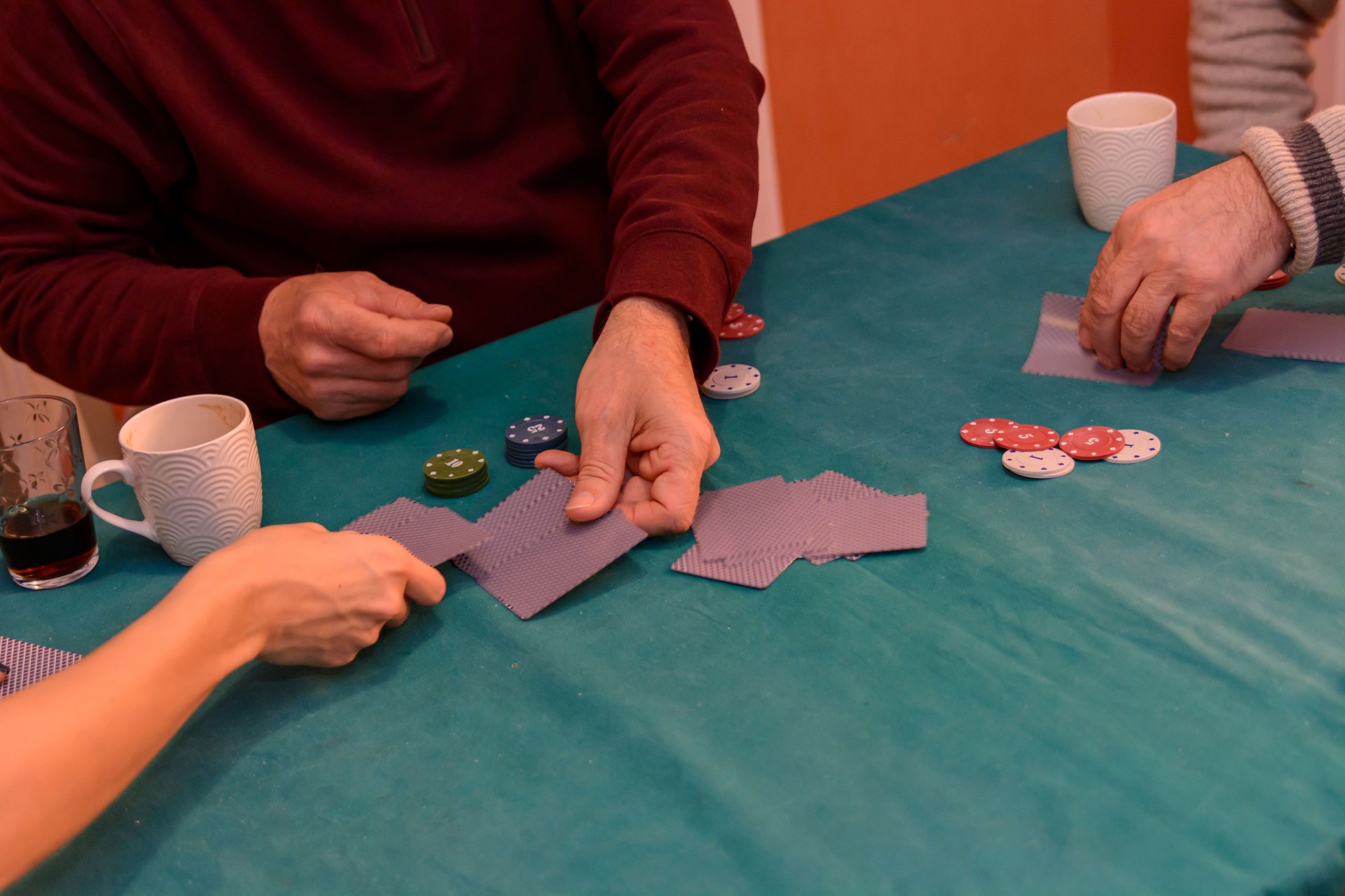 Older participants at a social meeting are having lots of fun playing cards.